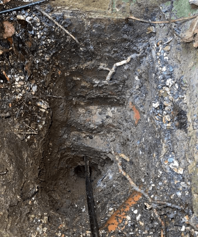 Made ground over virgin stiff brown silty clay in the pit face
