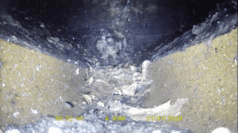CCTV drainage survey frame showing material inside the drain